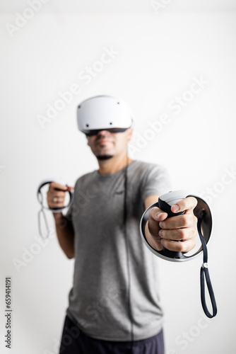 Young man using VR headset. Guy playing with VR glasses