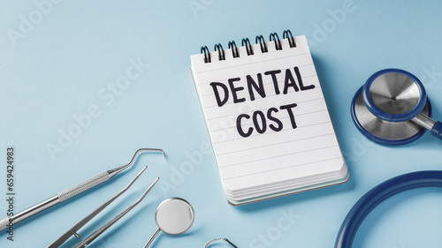 Dental cost concept with dental instruments on blue background