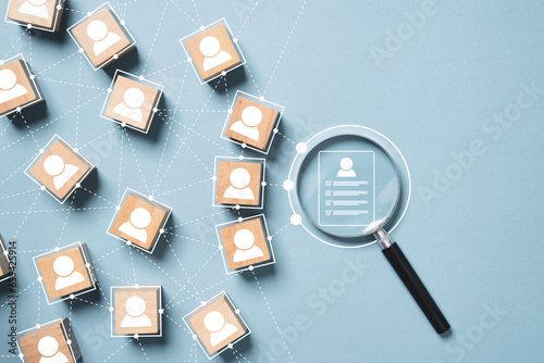 Cuadro en lienzo Resume icon inside of magnifier glass linkage with human icon on blue background for searching of human development recruitment concept