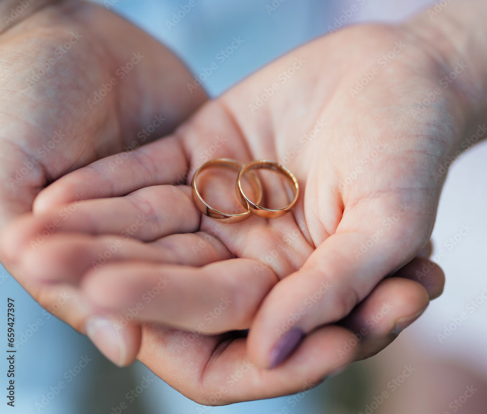 Young couple's hands with engagement rings Young couple's hands with engagement rings