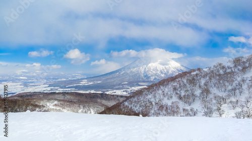 Viewing a snowy volcano from the top of ski slope hill (Niseko, Hokkaido, Japan) photo