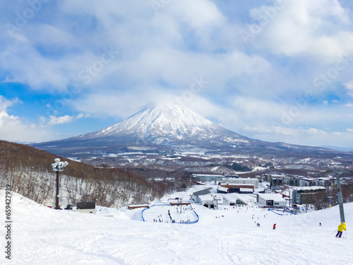 Ski slope with the view of snowy volcano (Niseko, Hokkaido, Japan) photo