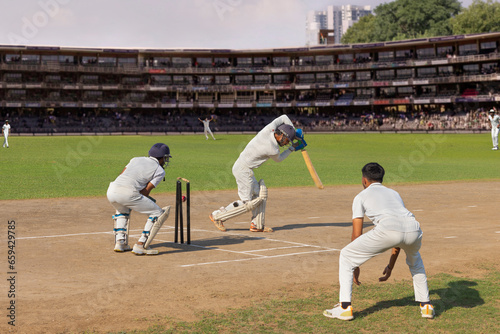 Batsman bowled out after  missing the ball while trying to defend it, while playing a cricket match
