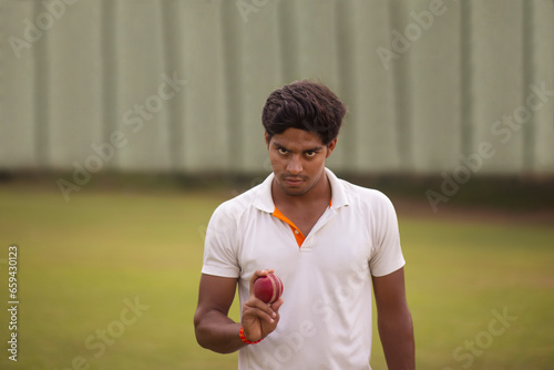 A portrait of a pace bowler preparing to deliver a ball during cricket match photo