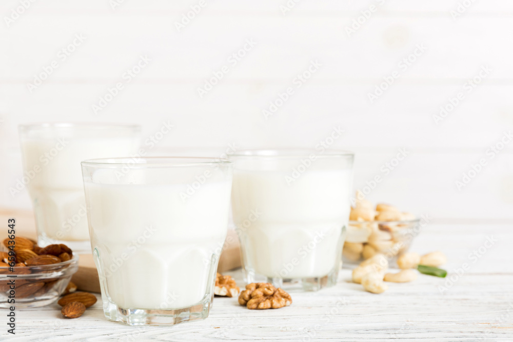 Set or collection of various vegan milk almond, cashew, on table background. Vegan plant based milk and ingredients, top view Set or collection of various vegan milk almond, cashew, on table background. Vegan plant based milk and ingredients, top view