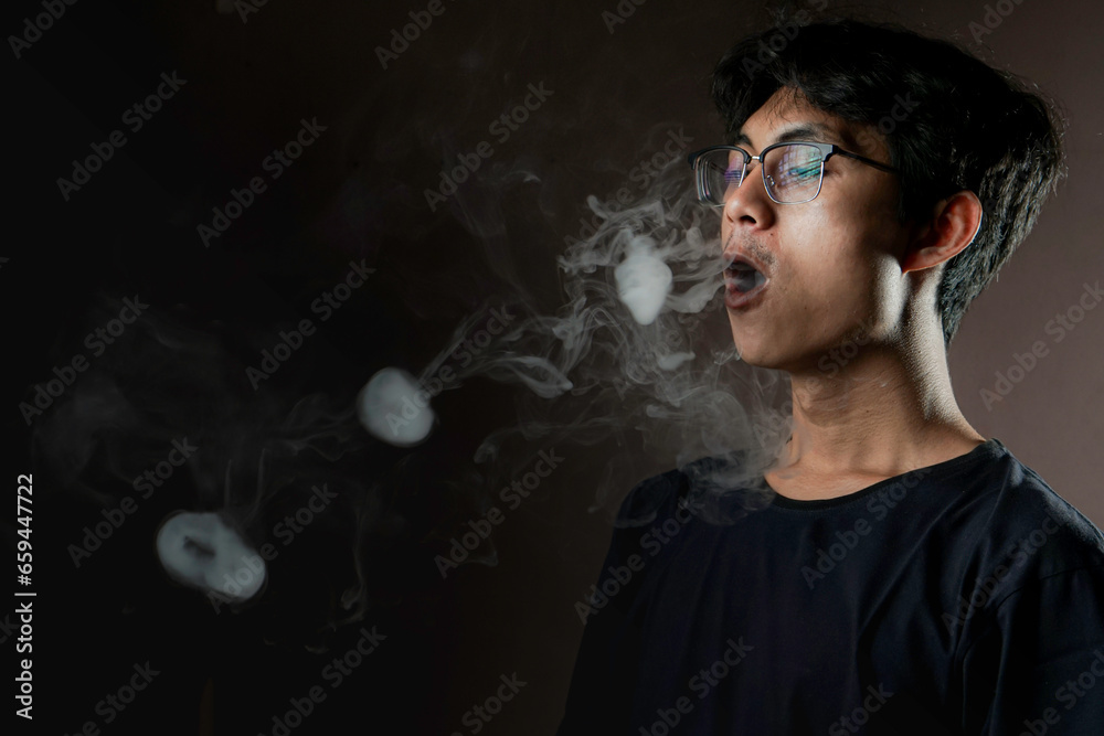 Man making smoke ring with vapor Man making smoke ring with vapor