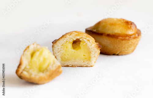 Pasticciotto leccese pastry filled with egg custard cream on a white table, close up