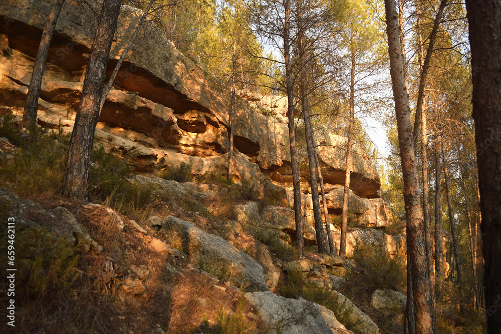 Obraz premium View of rock walls formed by layers of strata during sunset time on mount La Muela in Rincón de Ademuz on the Iberian Peninsula