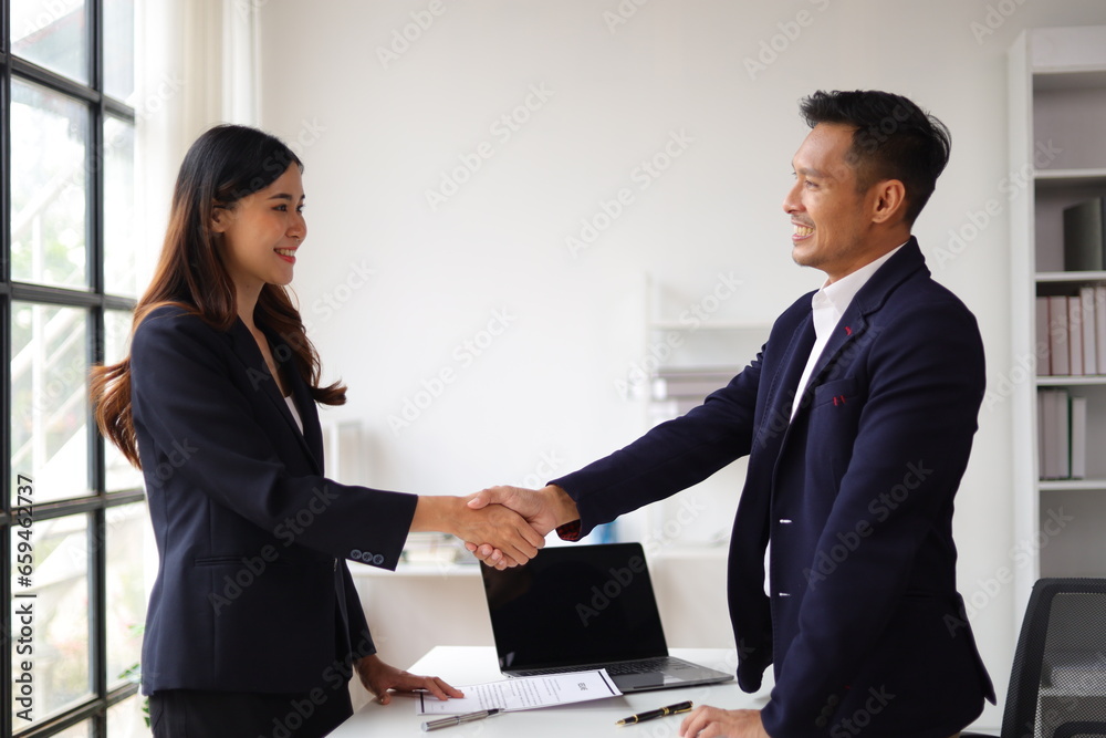 Business partners and colleagues shaking hands at work cooperation. Job applicant shaking hands with executives in office room at job interview. Business partners and colleagues shaking hands at work cooperation. Job applicant shaking hands with executives in office room at job interview.