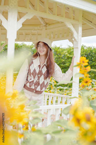 Portrait young woman in a field of sunflowers, Happiness asian woman in a field of sunflowers, Portrait asian woman in a field of sunflowers 