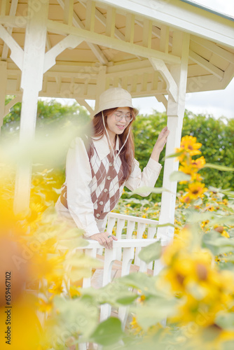 Portrait young woman in a field of sunflowers, Happiness asian woman in a field of sunflowers, Portrait asian woman in a field of sunflowers 