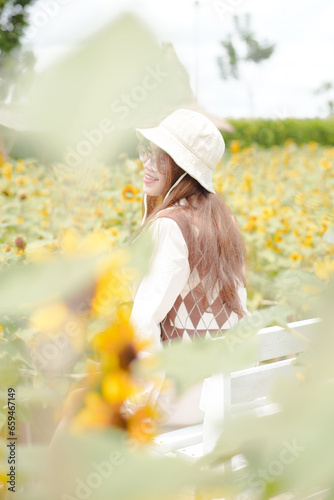 Portrait young woman in a field of sunflowers, Happiness asian woman in a field of sunflowers, Portrait asian woman in a field of sunflowers 