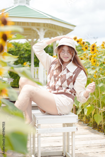 Portrait young woman in a field of sunflowers, Happiness asian woman in a field of sunflowers, Portrait asian woman in a field of sunflowers 