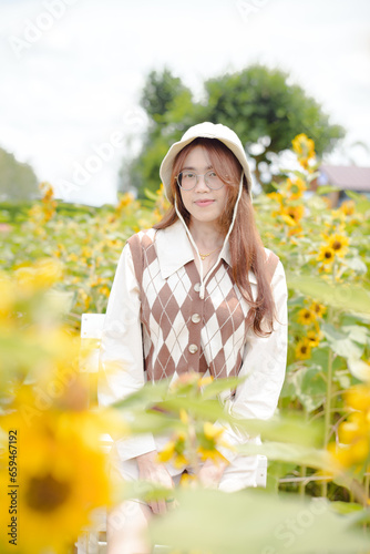 Portrait young woman in a field of sunflowers, Happiness asian woman in a field of sunflowers, Portrait asian woman in a field of sunflowers 