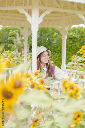 Portrait young woman in a field of sunflowers, Happiness asian woman in a field of sunflowers, Portrait asian woman in a field of sunflowers 