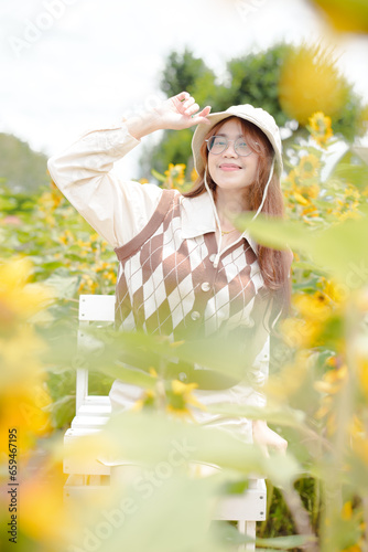 Portrait young woman in a field of sunflowers, Happiness asian woman in a field of sunflowers, Portrait asian woman in a field of sunflowers 