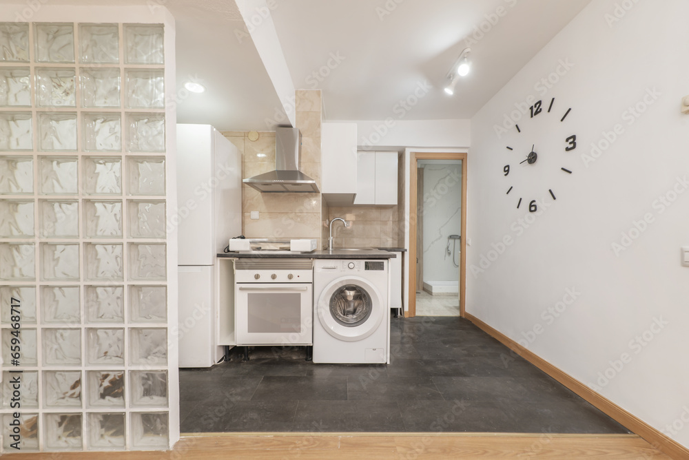 Apartment with an open kitchen equipped with white furniture