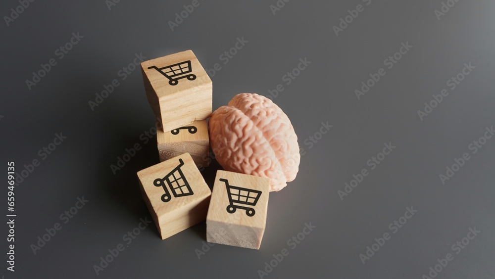 A human brain and wooden blocks with shopping carts icon. Consumer behavior, impulse buying and shopping addiction concept. - obrazy, fototapety, plakaty 