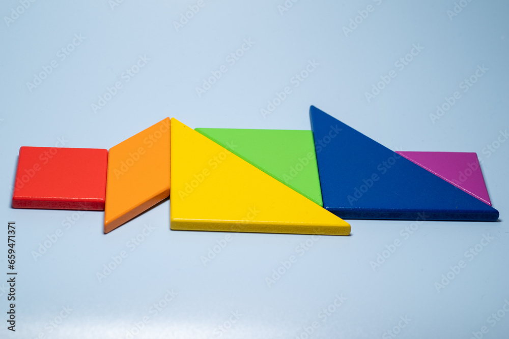 Close-up of the colorful tangram on blue background,LGBTQ(LGBTQ+) community flag colour,rainbow colours Close-up of the colorful tangram on blue background,LGBTQ(LGBTQ+) community flag colour,rainbow colours
