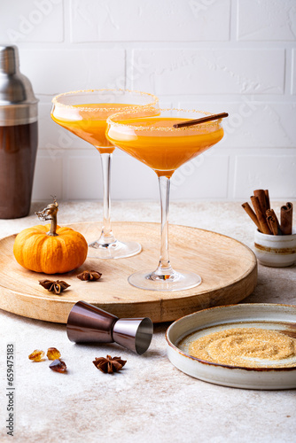 Halloween, Thanksgiving or fall cocktail pumpkin martini, homemade festive seasonal drink pumpkintini with cinnamon photo