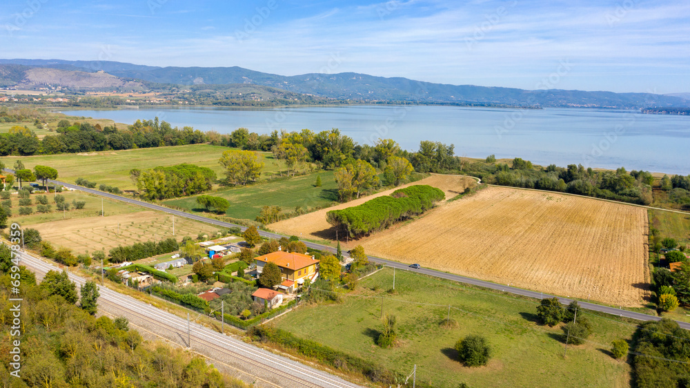Aerial view of Lake Trasimeno. Lake Thrasimene is located in the province of Perugia, in the Umbria region of Italy on the border with Tuscany. Around there are cultivated fields.