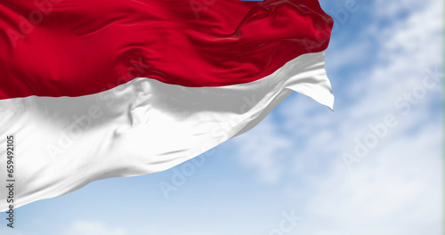 Indonesia national flag waving in the wind on a clear day. Two horizontal red and white stripes of equal width. 3d illustration render. Rippling fabric