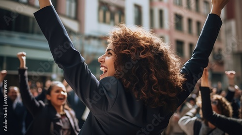 People and Success: Rear view of woman wearing suit celebrating success on the street, woman raising hands in joy, victory, leader,