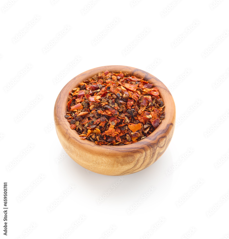 Pepper flakes spice in wooden bowl isolated on white background Pepper flakes spice in wooden bowl isolated on white background