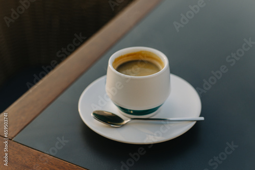 Cup of black coffee on a table in a cafe.