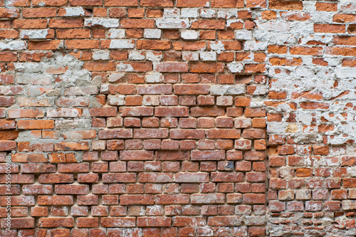 Vintage damaged red brick wall.
