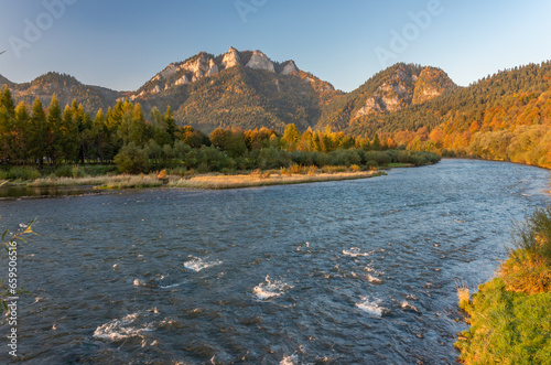 Dunajec river and Trzy Korony (Three Crowns) peak in Pieniny mountains, Little Poland, sunny autumn afternoon