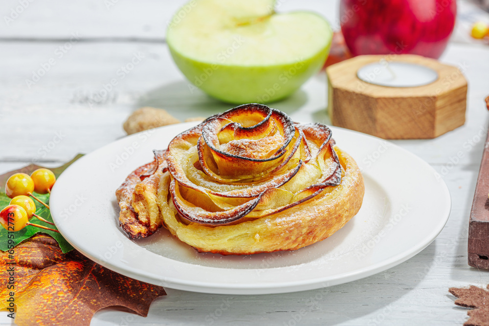 Apple roses pie with sugar powder. Traditional autumn baking, fall decor, flat lay