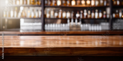 empty wooden restaurant bar counter with blurred bottle shelves in background