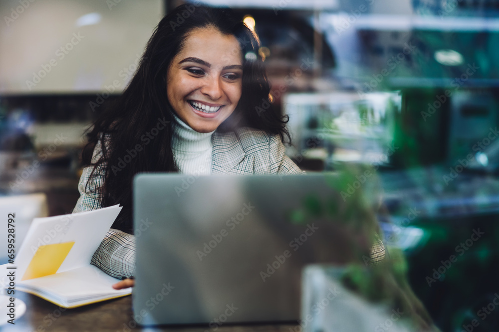 Laughing lady working with laptop in coffee shop Laughing lady working with laptop in coffee shop
