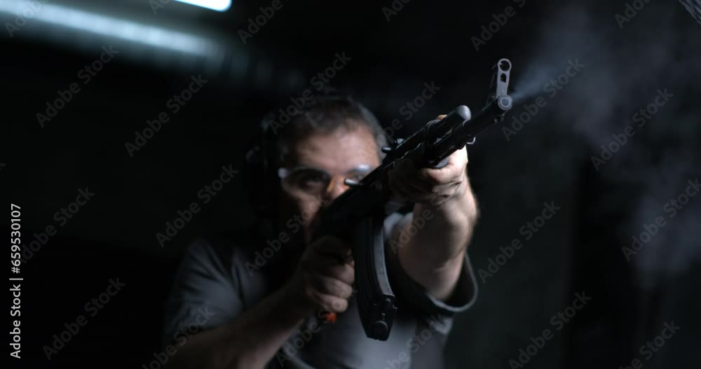 High-Speed 800fps Slow-Motion Shooting with AK-47, Man Aiming and Firing Kalashnikov Rifle, low-angle shot High-Speed 800fps Slow-Motion Shooting with AK-47, Man Aiming and Firing Kalashnikov Rifle, low-angle shot