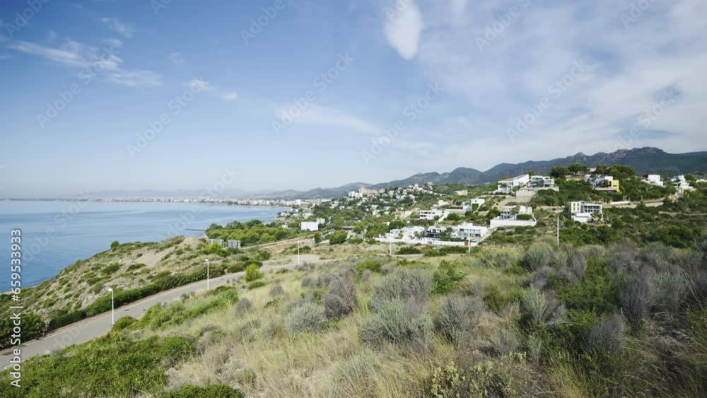 City of Benicassim on the Mediterranean Sea in Spain. The green path between the stones is a popular place for outdoor activities. City of Benicassim on the Mediterranean Sea in Spain. The green path between the stones is a popular place for outdoor activities.