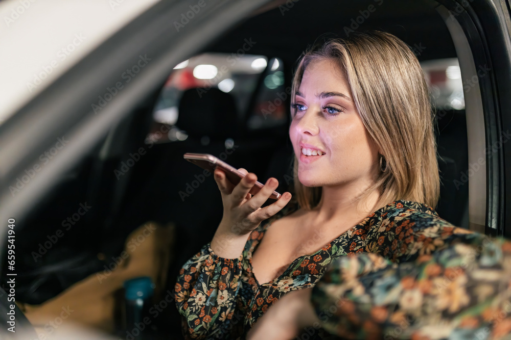 Young woman making video call over smartphone in car