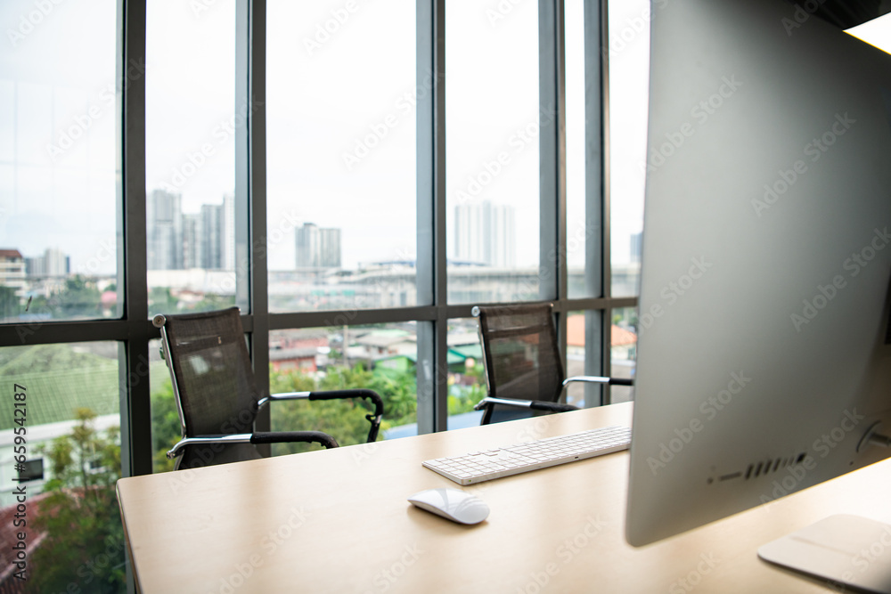 Office workplace with computer on wooden table and city view Office workplace with computer on wooden table and city view