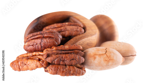 Pecan nuts in wooden scoop, isolated on white background. Shelled and unshelled pecan. Clipping path.