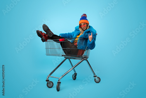 Crazy female in shopping cart photo