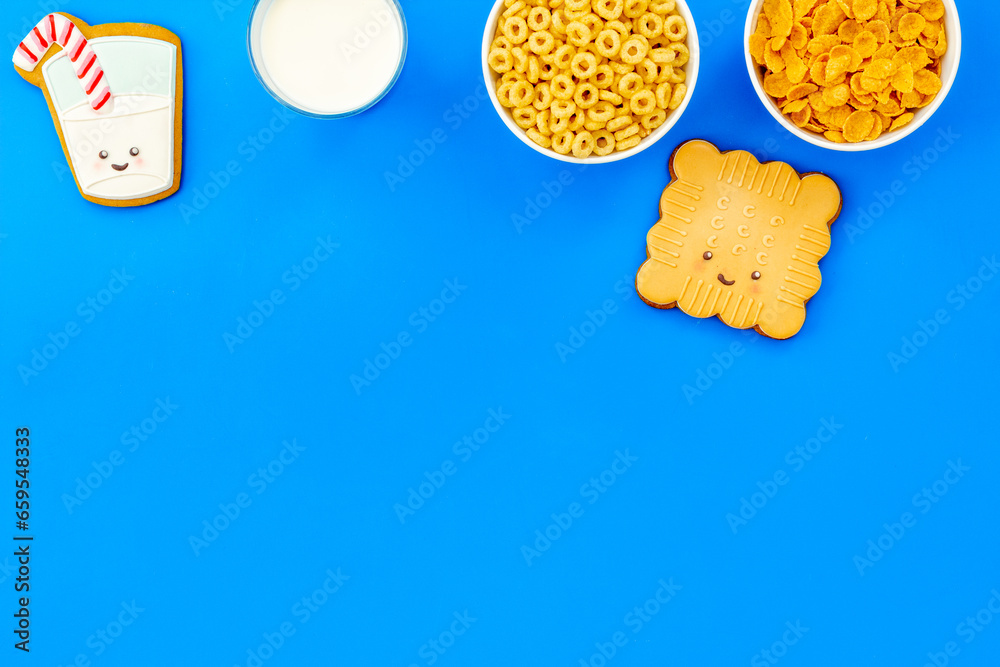 Kids breakfast with milk and funny cookies with cornflakes