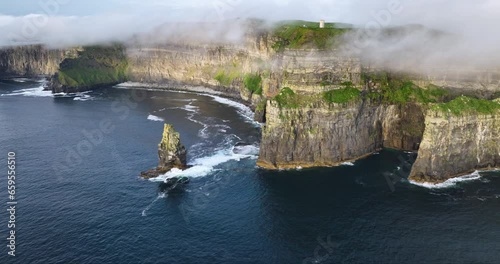 Aerial of coastal cliffs Moher shrouded in low clouds 4k