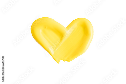 Yellow color paint heart shape texture isolated on white background. Yellow creamy swatch, macro. Cosmetic beauty product sample. Beautiful textured golden yellow stroke. Yellow paint smear
