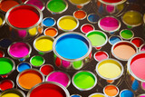 A top-down view of the opened aluminum cans with colorful paint inside. Vibrant