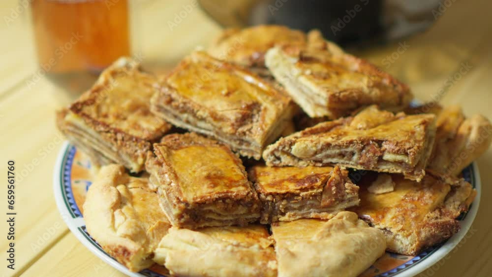 Traditional oriental sweets, baklava on plate folded into pieces. Traditional oriental sweets, baklava on plate folded into pieces.