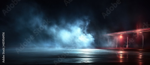 Wet asphalt, reflection of neon lights, a searchlight, smoke © Tisha