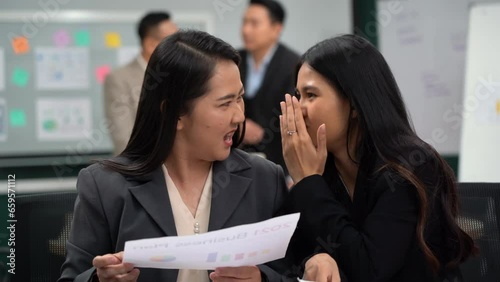 group of asian office worker woman talking or whispering gossip with colleague rumors to coworker in office