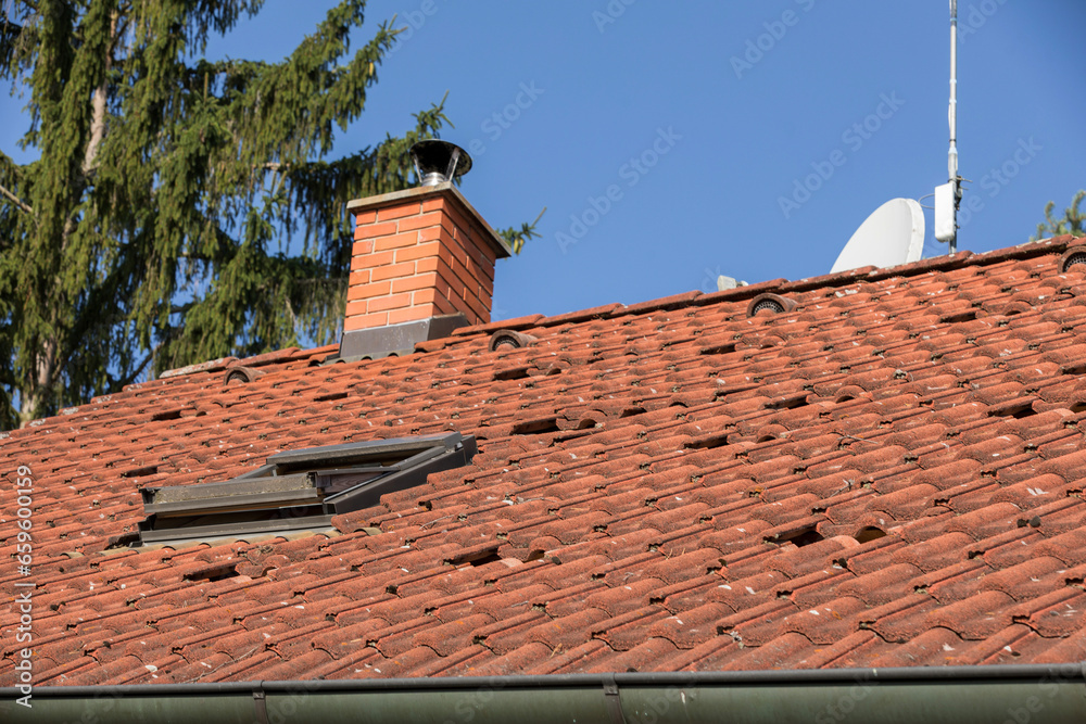 the roof of a family house with red tiles, red bags on the roof of the house ready for photovoltaic installations, installation of photovoltaic panels