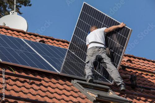 Workers prepare the roof for the installation of solar panels. Two men on the roof of a family house. Photovoltaic installation