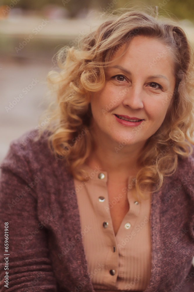 Street portrait of adult cute blonde woman close-up selective focus